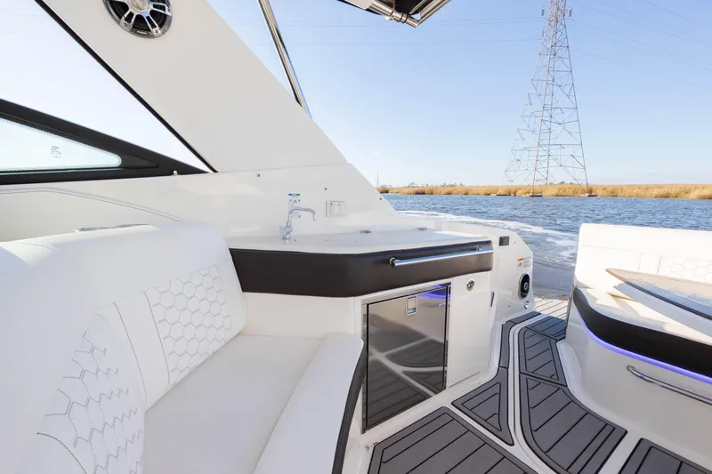  Yacht Photos Pics 2019 Sea Ray 320 Sundancer OB interior with white seating and water view.