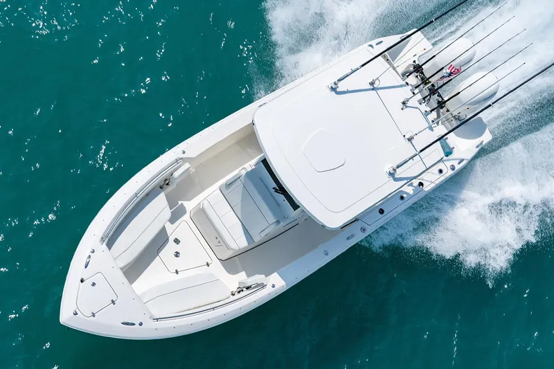  Yacht Photos Pics Manufacturer Provided Image: 2025 Pursuit S 268 Sport boat cruising on clear blue water.
