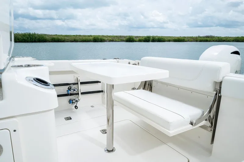  Yacht Photos Pics Manufacturer Provided Image: 2025 Pursuit S 268 Sport boat interior with white seating and table on calm water.