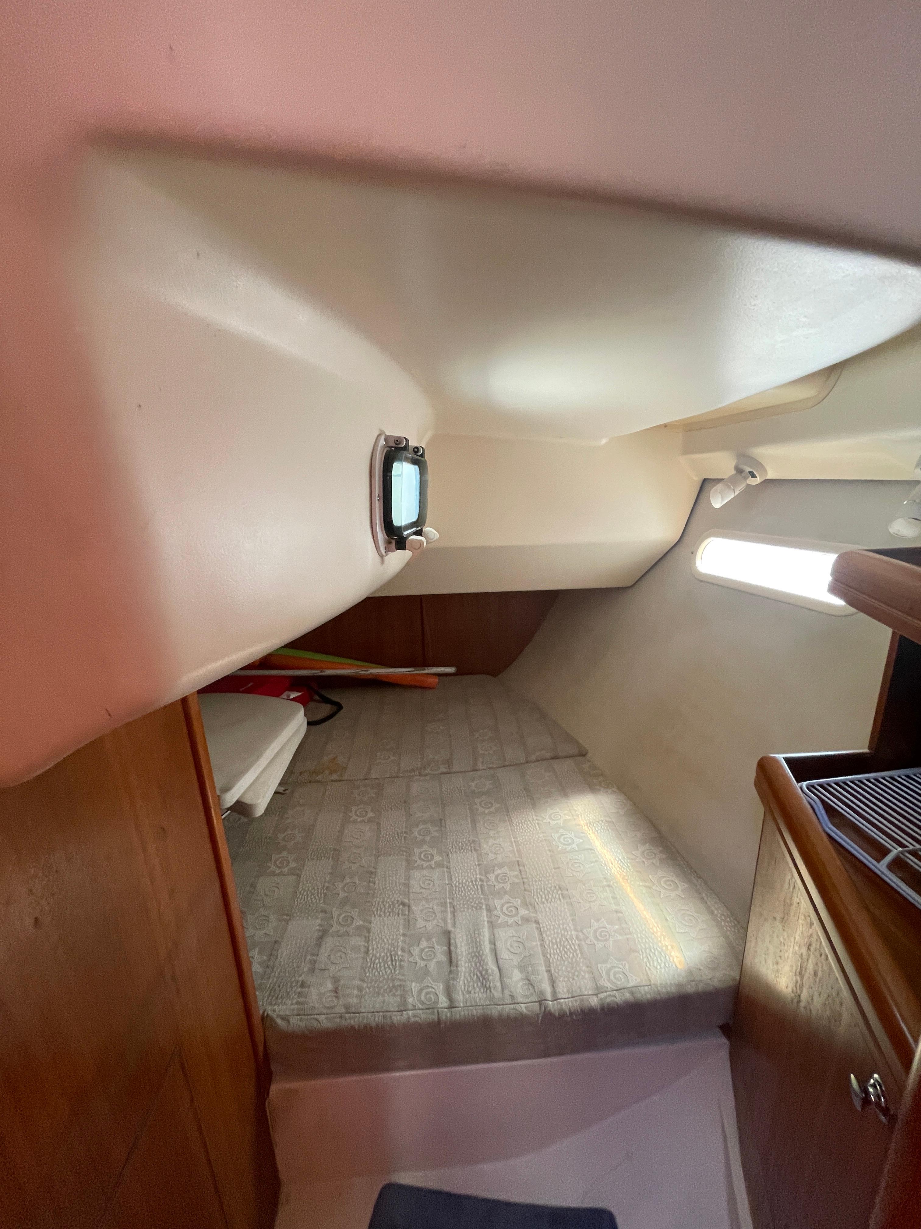 Interior cabin of a 2001 Hunter 306 sailboat with a cozy sleeping area.