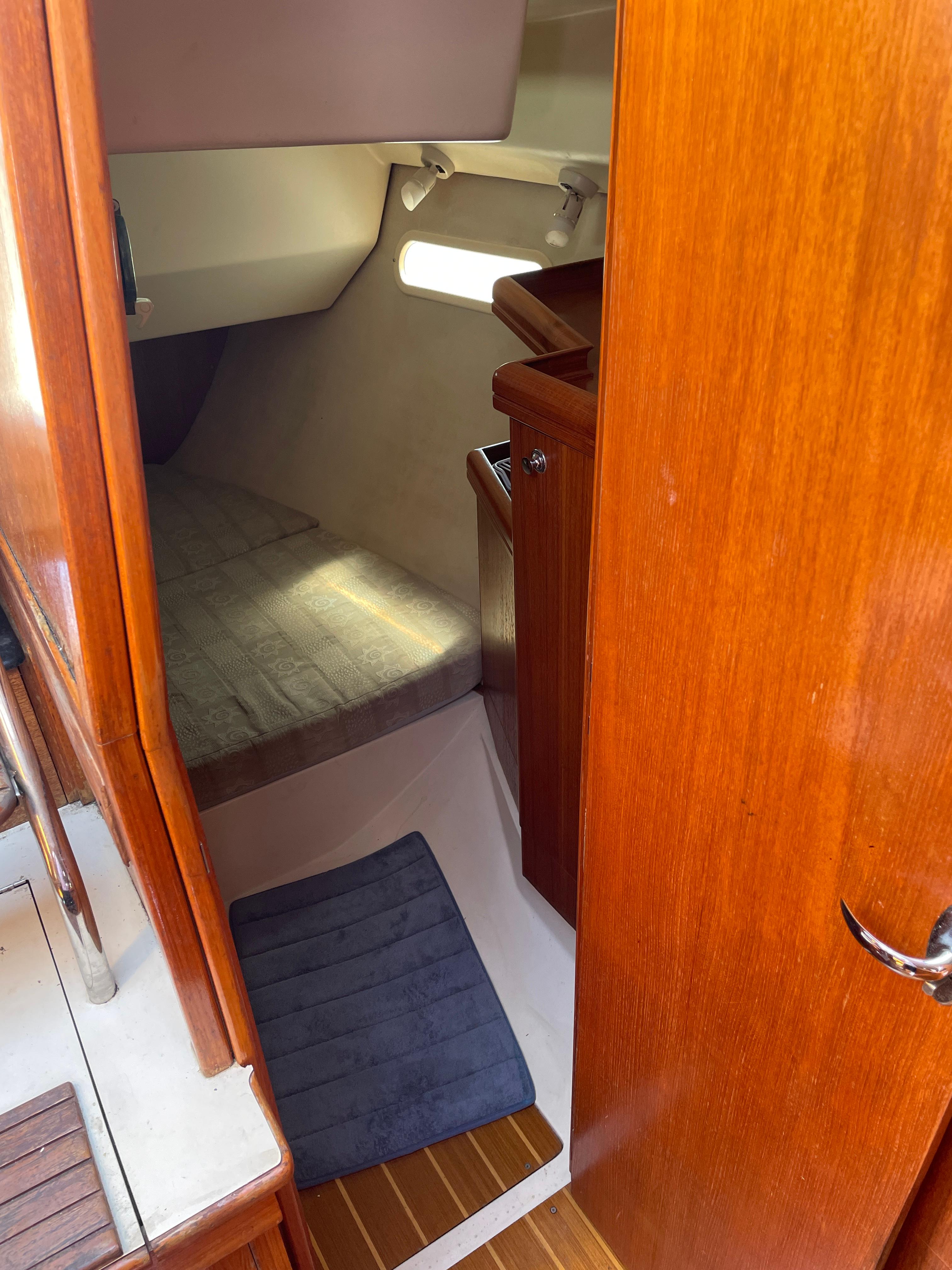 Interior cabin of a 2001 Hunter 306 sailboat with wooden finishes.