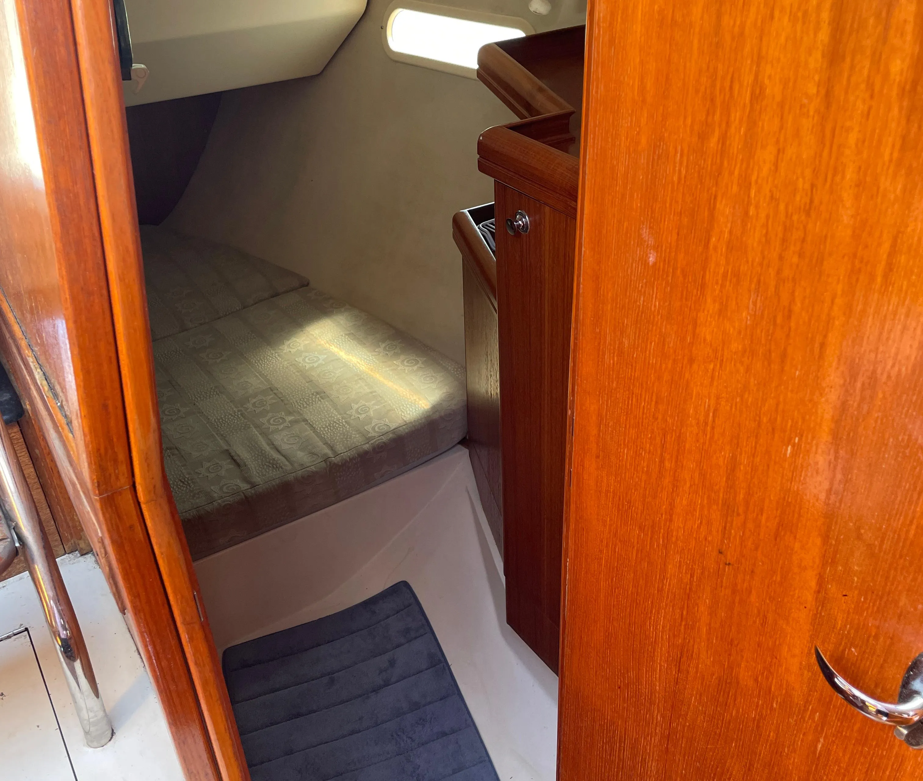Interior cabin of a 2001 Hunter 306 sailboat with wooden finishes.