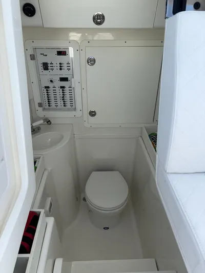  Yacht Photos Pics 2018 SeaVee 340Z boat interior with compact bathroom and control panel.