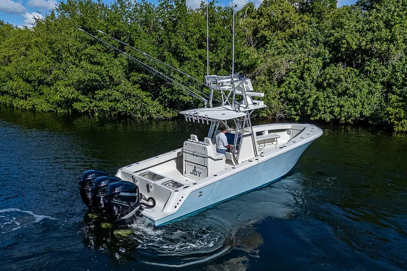  Yacht Photos Pics 2018 SeaVee 370z boat cruising on a scenic waterway with lush greenery.