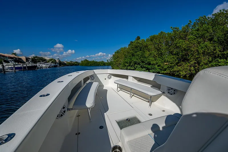  Yacht Photos Pics 2018 SeaVee 370z boat interior with seating, surrounded by lush greenery and calm waters.
