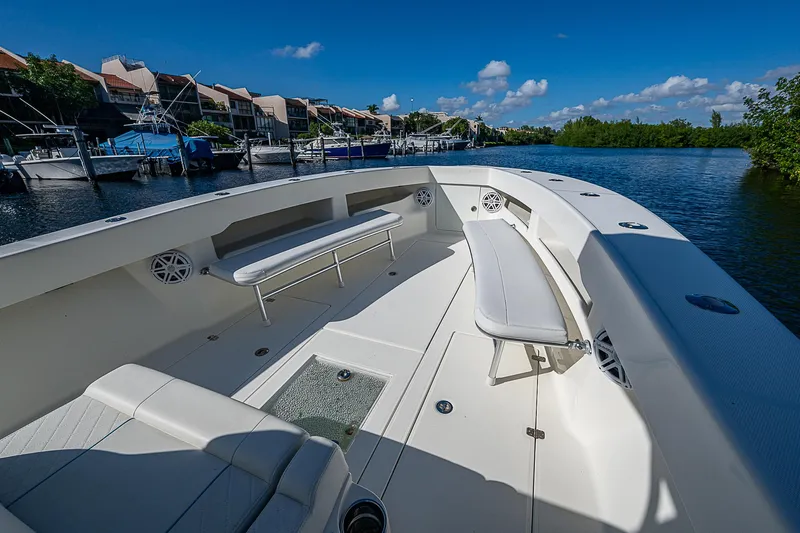  Yacht Photos Pics 2018 SeaVee 370z boat with spacious deck, docked by waterfront homes.