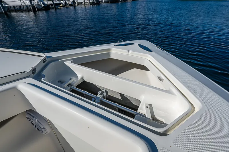  Yacht Photos Pics 2018 SeaVee 370z boat with open storage compartment on calm water.