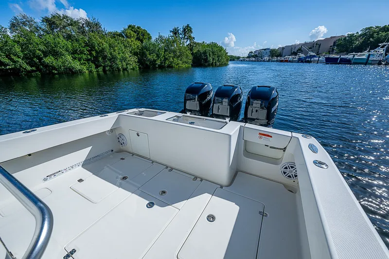  Yacht Photos Pics 2018 SeaVee 370z boat with triple engines on a serene waterway.