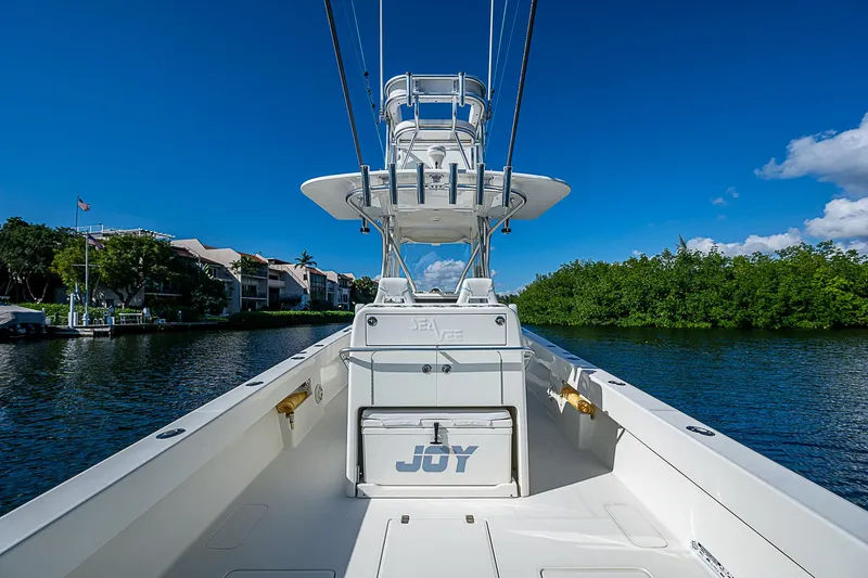  Yacht Photos Pics 2018 SeaVee 370z boat on water, clear sky, lush greenery.