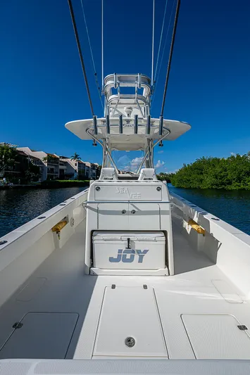  Yacht Photos Pics 2018 SeaVee 370z boat on water, clear sky, lush greenery.