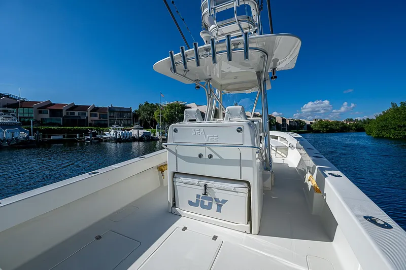  Yacht Photos Pics 2018 SeaVee 370z boat on calm water, featuring spacious deck and fishing equipment.