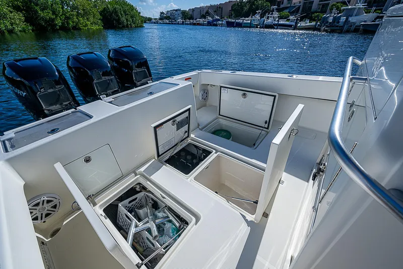  Yacht Photos Pics 2018 SeaVee 370z boat deck with open storage compartments and triple outboard engines.