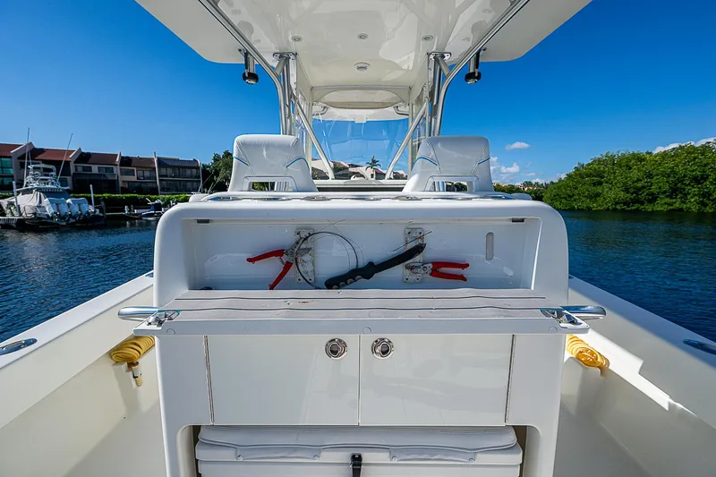  Yacht Photos Pics 2018 SeaVee 370z boat interior with helm station and seating, docked by waterfront homes.
