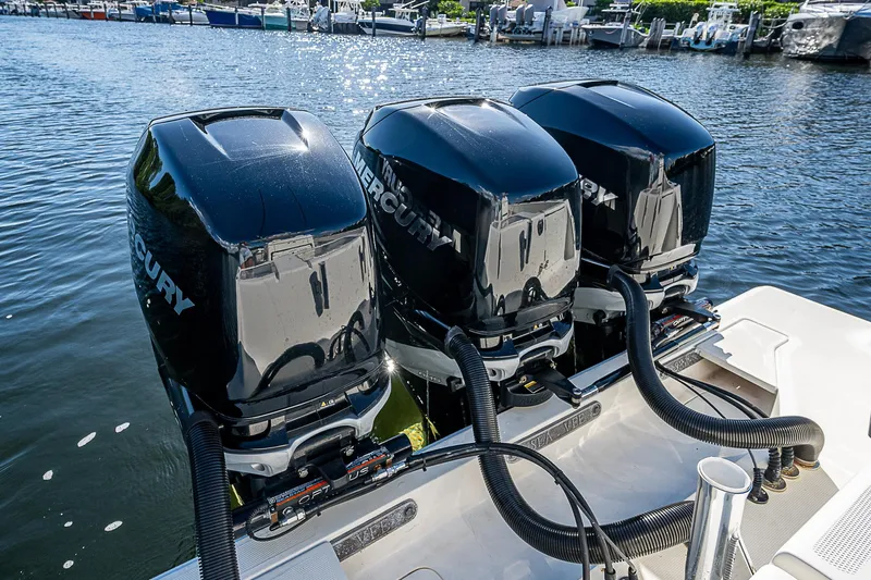  Yacht Photos Pics Triple Mercury outboard engines on 2018 SeaVee 370z boat, docked by the water.