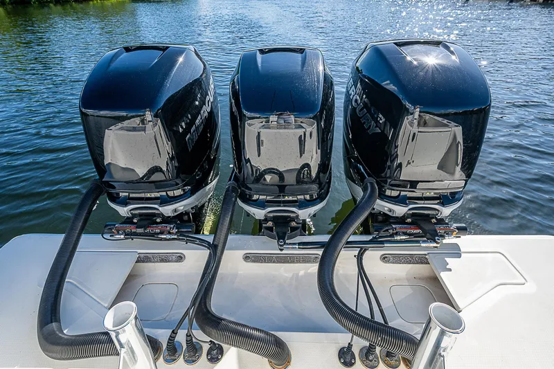  Yacht Photos Pics Triple Mercury outboard engines on a 2018 SeaVee 370z boat, docked on calm water.