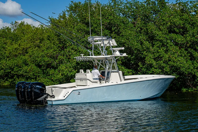  Yacht Photos Pics 2018 SeaVee 370z boat on calm water near lush greenery.
