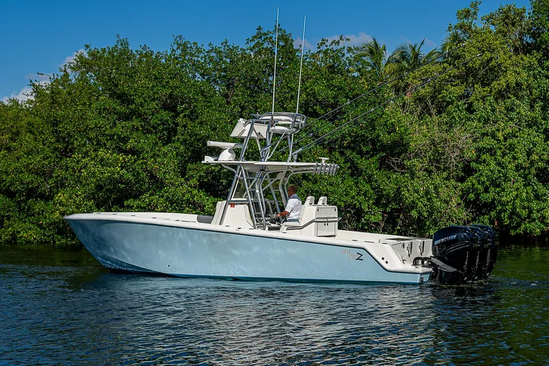  Yacht Photos Pics 2018 SeaVee 340Z boat on calm water, surrounded by lush greenery.