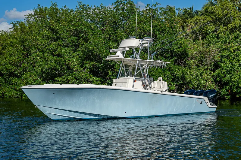  Yacht Photos Pics 2018 SeaVee 340Z boat on calm water, surrounded by lush greenery.
