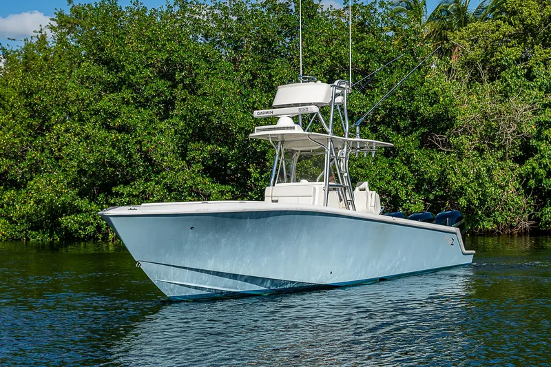  Yacht Photos Pics 2018 SeaVee 340Z boat on calm water, surrounded by lush greenery.