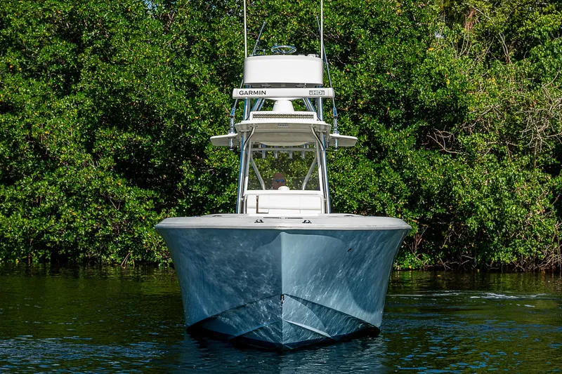  Yacht Photos Pics 2018 SeaVee 340Z boat on water, surrounded by lush greenery.