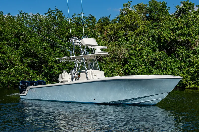  Yacht Photos Pics 2018 SeaVee 340Z boat on calm water, surrounded by lush greenery.