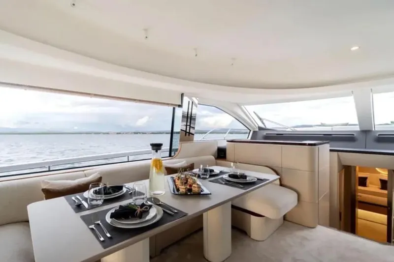  Yacht Photos Pics Luxurious dining area on 2022 Azimut 68 FLY yacht with ocean view.