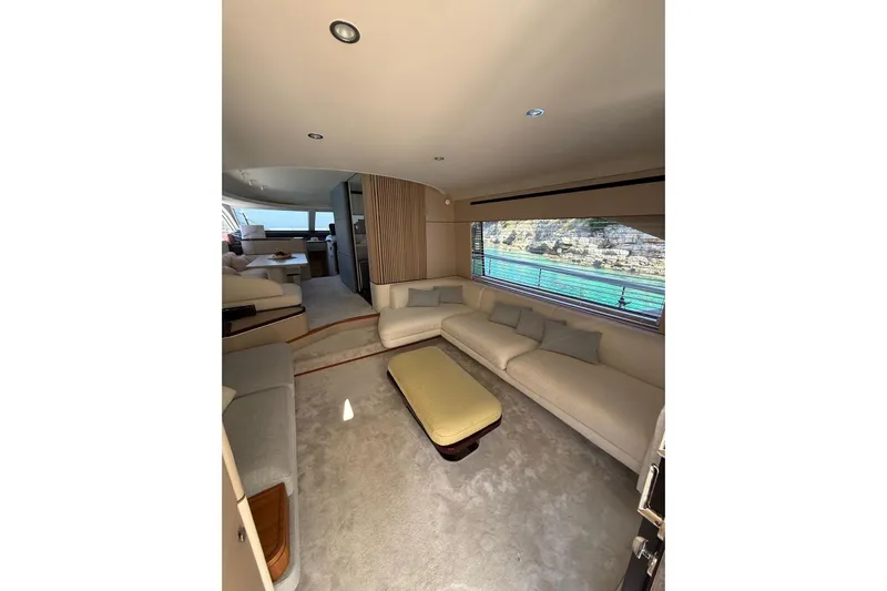  Yacht Photos Pics Luxurious interior of 2022 Azimut 68 FLY yacht with spacious seating and scenic window view.