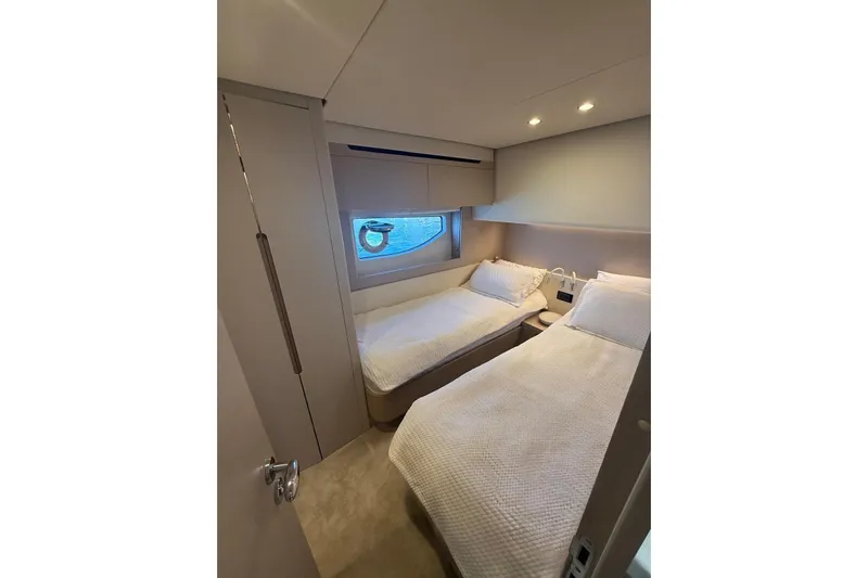  Yacht Photos Pics Luxurious twin cabin interior on 2022 Azimut 68 FLY yacht, featuring modern design and cozy bedding.