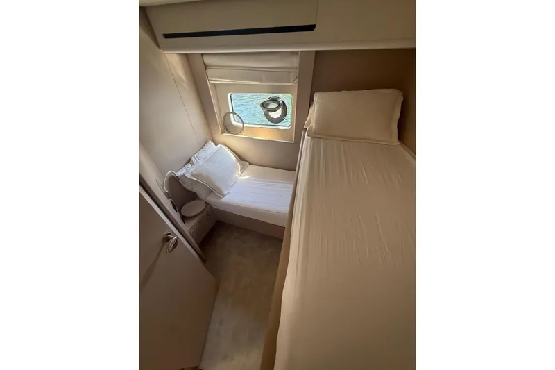  Yacht Photos Pics Interior cabin of 2022 Azimut 68 FLY yacht with twin beds and window view.