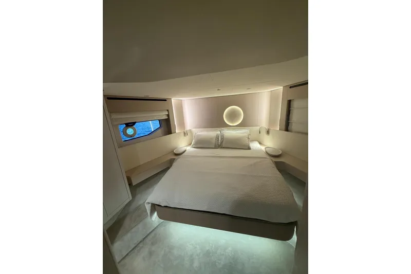  Yacht Photos Pics Luxurious bedroom interior of 2022 Azimut 68 FLY yacht, featuring modern design and ambient lighting.