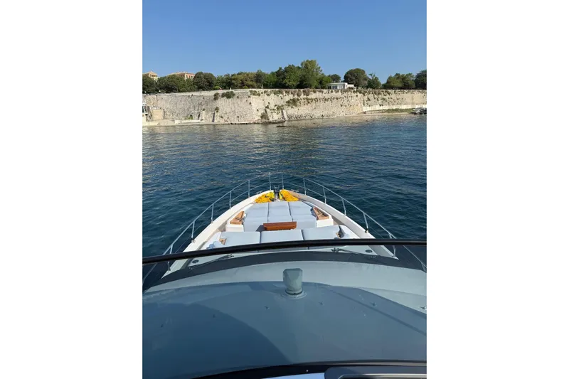  Yacht Photos Pics Azimut 68 FLY 2022 yacht cruising near a scenic coastal area.