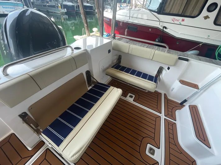 Beautiful Boat At Great Price! Yacht Photos Pics 2023 Ranger Tugs R-25 boat interior with cushioned seating and teak flooring.