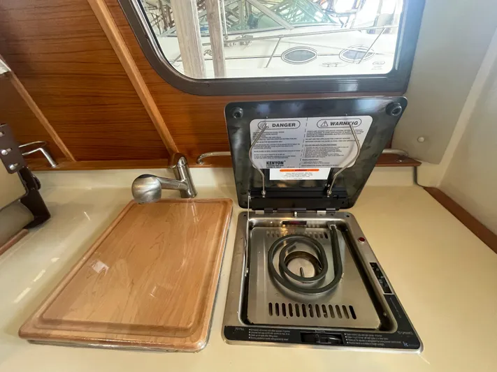 Beautiful Boat At Great Price! Yacht Photos Pics 2023 Ranger Tugs R-25 kitchen with stove and cutting board.