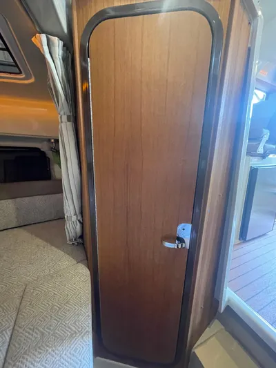 Beautiful Boat At Great Price! Yacht Photos Pics 2023 Ranger Tugs R-25 interior cabin door with wood finish and modern design.