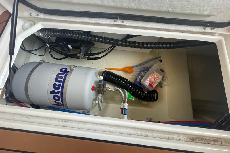 Beautiful Boat At Great Price! Yacht Photos Pics 2023 Ranger Tugs R-25 storage compartment with water heater and accessories.