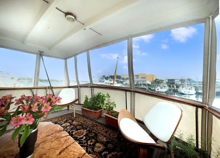 Shangri-la Yacht Photos Pics 1978 Cheoy Lee Ocean Access Deeded Slips with scenic marina view and cozy seating area.