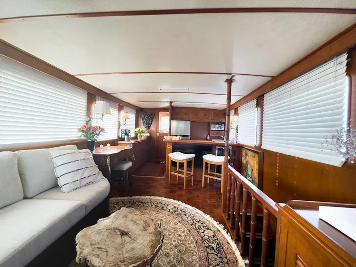 Shangri-la Yacht Photos Pics Interior of 1978 Cheoy Lee yacht with cozy seating, wooden decor, and natural light.