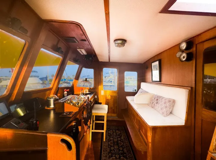 Shangri-la Yacht Photos Pics 1978 Cheoy Lee Ocean access deeded slips interior with wooden helm, seating, and nautical decor.