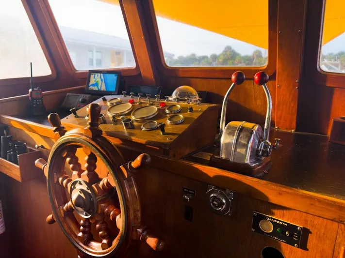 Shangri-la Yacht Photos Pics 1978 Cheoy Lee Ocean Access Deeded Slips boat helm with wooden wheel and control panel.