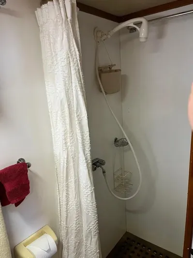 Shangri-la Yacht Photos Pics 1978 Cheoy Lee Ocean Access bathroom with shower, curtain, and towel.