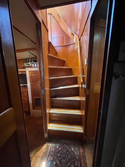 Shangri-la Yacht Photos Pics 1978 Cheoy Lee yacht interior with wooden staircase and cozy cabin view.
