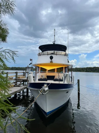 Shangri-la Yacht Photos Pics 1978 Cheoy Lee yacht docked, ocean access deeded slips, under cloudy sky.
