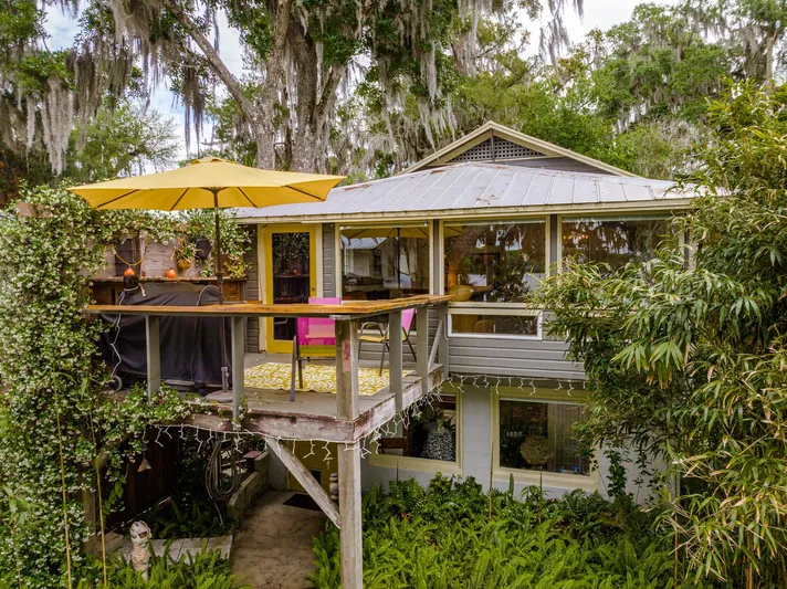 Shangri-la Yacht Photos Pics Charming 1978 Cheoy Lee home with ocean access, featuring a cozy deck and lush greenery.
