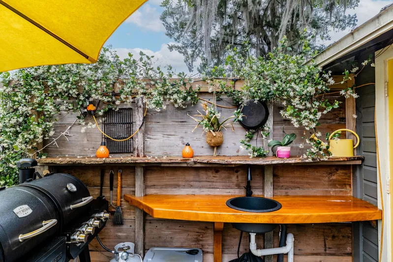 Shangri-la Yacht Photos Pics Outdoor kitchen with wooden counter, grill, and plants; Cheoy Lee Ocean access deeded slips, 1978.