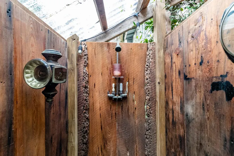 Shangri-la Yacht Photos Pics Rustic outdoor shower with wooden panels and vintage fixtures, Cheoy Lee Ocean access deeded slips, 1978.