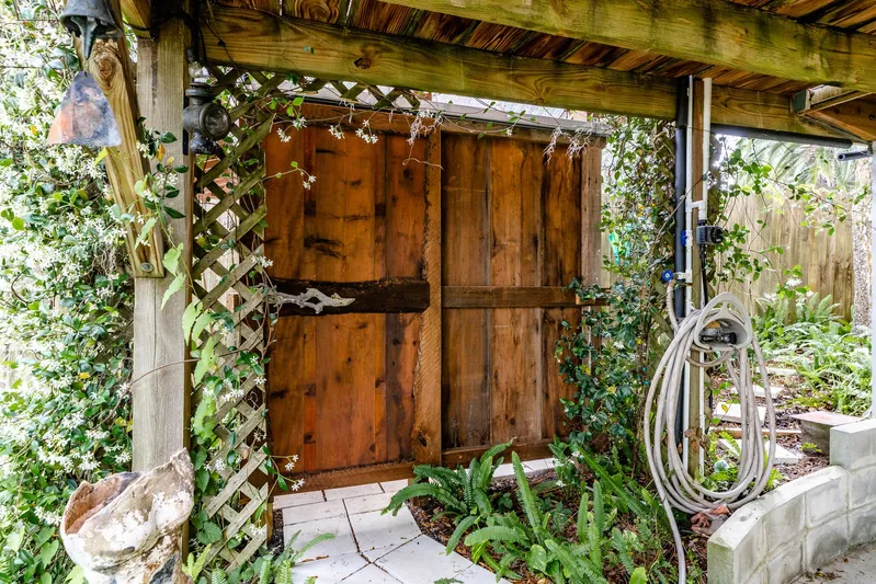Shangri-la Yacht Photos Pics Wooden garden gate surrounded by lush greenery and vines, Cheoy Lee Ocean access deeded slips, 1978.