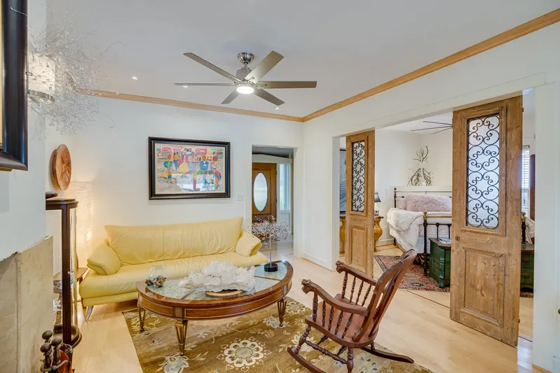 Shangri-la Yacht Photos Pics Cozy living room with yellow sofa, wooden rocking chair, and decorative sliding doors.