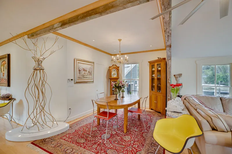 Shangri-la Yacht Photos Pics Elegant dining area with modern decor, wooden table, and vibrant red rug.