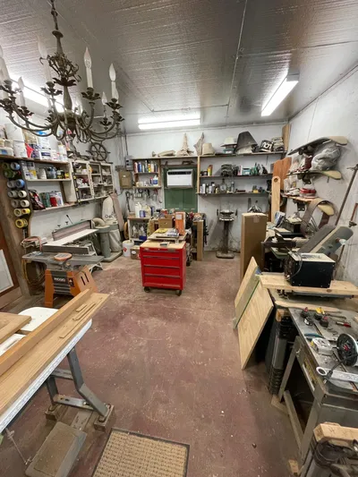 Shangri-la Yacht Photos Pics Woodworking workshop with tools, shelves, and chandelier; Cheoy Lee Ocean access deeded slips, 1978.