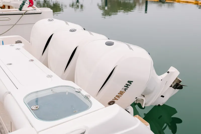  Yacht Photos Pics Triple Yamaha outboard engines on a 2010 Everglades 350LX boat at a marina.